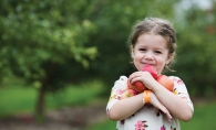 A girl holds apples at Apple Jack Orchards