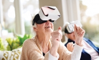 A senior at The Pillars of Shorewood Landing uses a WellnessVR headset.