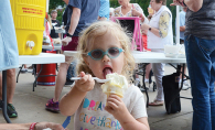 A girl enjoys an ice cream cone at the Excelsior Fire District dance.