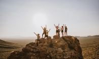 Group standing at the top of a rock.