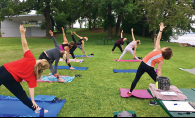 People stretch at Donation Yoga Excelsior on Lake Minnetonka.