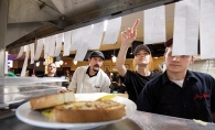 Joey Nova's Chef Gary Ezell and his employees review orders in the back kitchen.