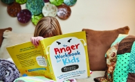 A young child using the Anger Workbook for Kids