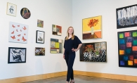 Anna Wander, member of the 2019 Senior Spotlight, stands in front of a wall of art.