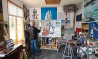 Local artist Richard Merchan paints in his studio in Greenwod