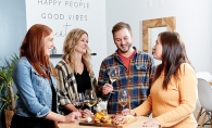 Friends gather around a table at The Vine Room in Hopkins