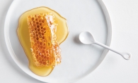 A honeycomb covered in honey from Ames Farm