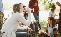 A group of friends enjoy glasses of wine while on vacation.