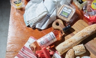 Various foods and drinks packed for a picnic.