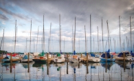 Sailboats float in the harbor at Wayzata Bay as a storm approaches Lake Minnetonka.