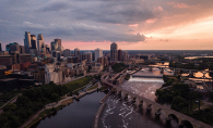 Minneapolis A shot of the Minneapolis skyline at sunset, with the Stone Arch Bridge in the foreground.