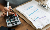 Woman doing finances with calculator 