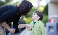 Boy and his mother saying goodbye before preschool.