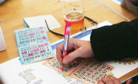 A person fills out their bingo card at the Bingo & Burgers by the Bay event.