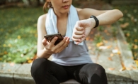 Woman looking at a fitness tracker.