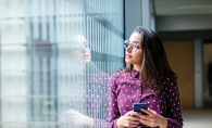 A woman browses social media on her phone