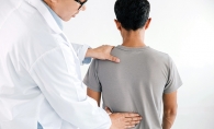 A chiropractor works on a patient's back at The Brost Clinic.