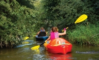 Kayakers paddle down Minnehaha Creek