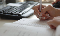 A businesswoman checks off items on her to-do list.