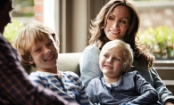 A stepmother sits with her stepchildren