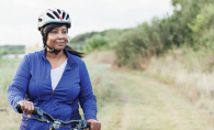 A woman bikes during a Minnesota summer.