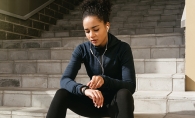 Young female runner checks her pulse