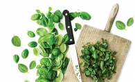 Leaves sit sliced on a cutting board in preparation for dinner party.