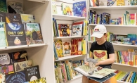 Young boy looking at books at bookstore The Thinking Spot.