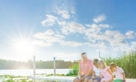 Dad with his three kids on the dock at Lake Tamarack.