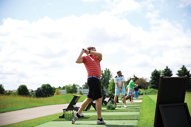A golfer swings at the Roger Miller Golf Classic 2019