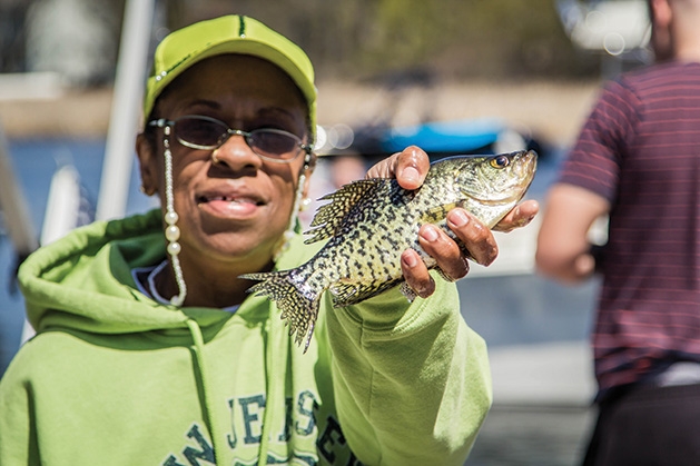 A fisherman holds their catch at the 51st Annual Minnesota Bound Crappie Contest
