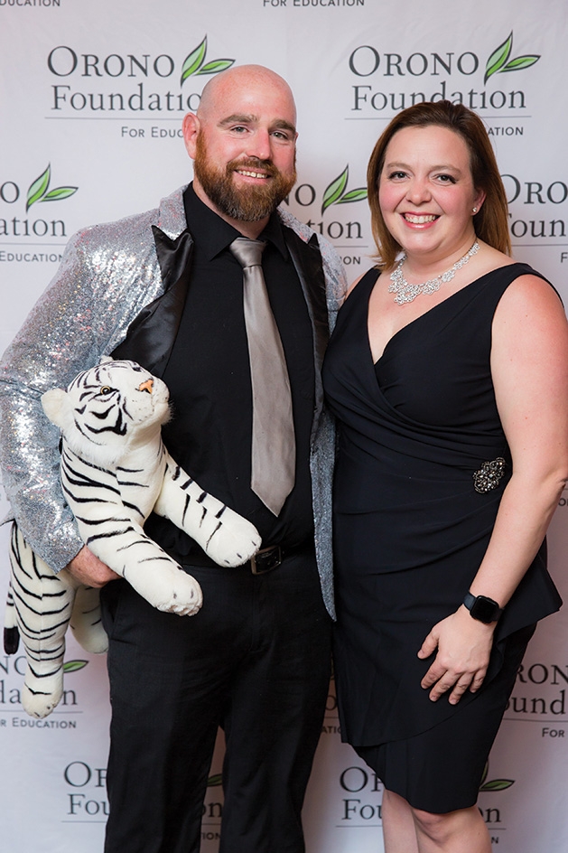 Mark Larsen and Leah Burek pose with a stuffed white tiger at the Orono Foundation's 2019 Red and Blue Bash