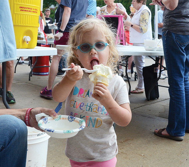 A girl enjoys an ice cream cone at the Excelsior Fire District dance.