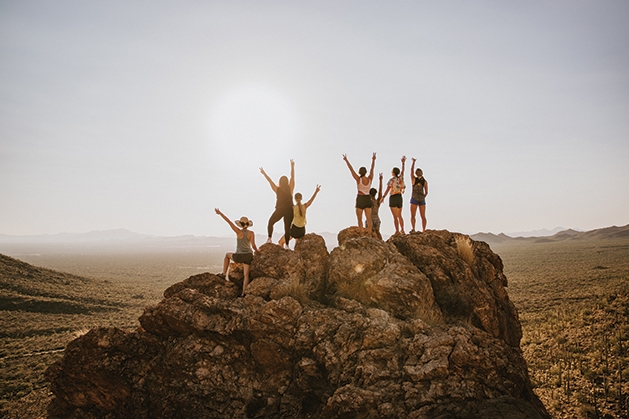 Group standing at the top of a rock.