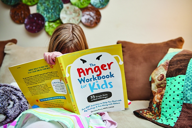 A young child using the Anger Workbook for Kids