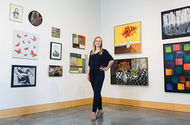 2019 Senior Spotlight Anna Wander Anna Wander, member of the 2019 Senior Spotlight, stands in front of a wall of art.