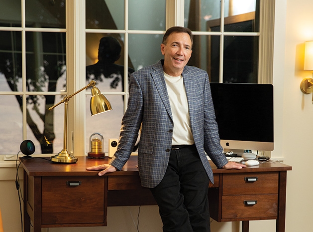 Paul Douglas leans on a desk in his Lake Minnetonka home.