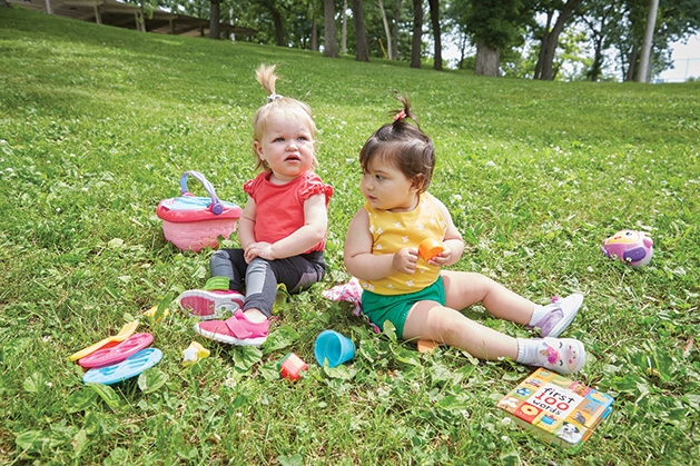 RubyScootz Two babies wearing RubyScootz play on a lawn.