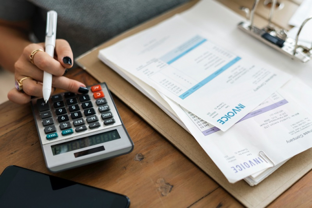 Woman doing finances with calculator 