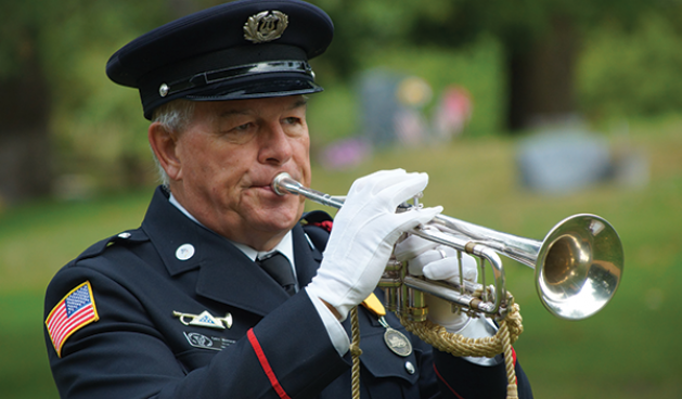 Wayzata resident Gary Marquardt plays a bugle.