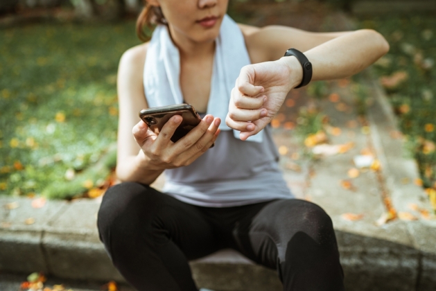 Woman looking at a fitness tracker.