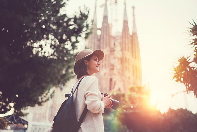 A woman takes a picture during a solo travel vacation.