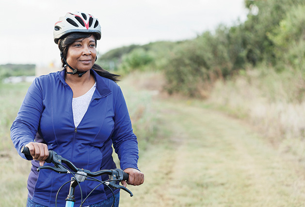 A woman bikes during a Minnesota summer.