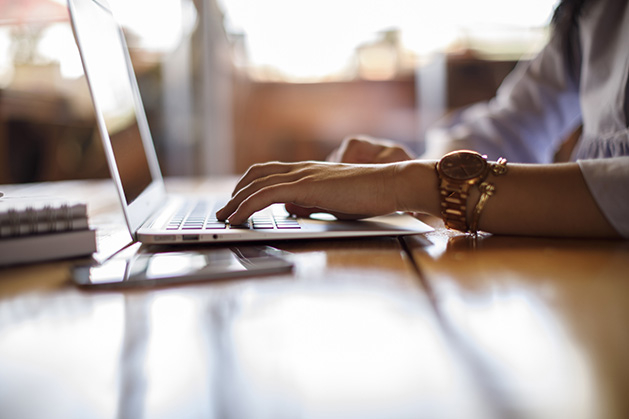 A woman on a laptop building a website from scratch.