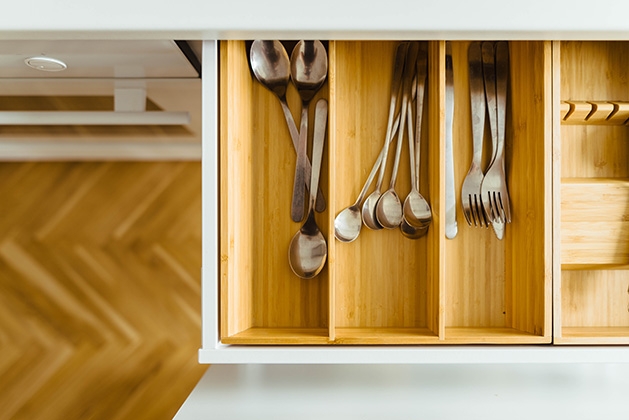 A kitchen drawer full of untensils.