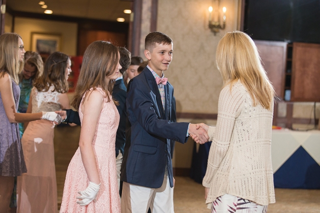 Young adults at a formal cotillion dance.