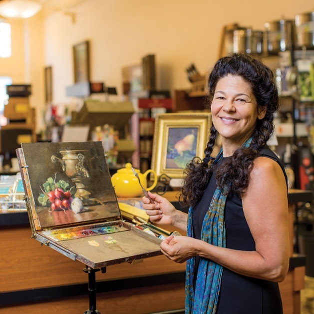 Artist Patricia Riley painting at The Abundant Kitchen.