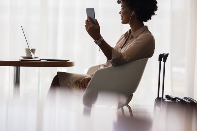 Woman working on devices while traveling.