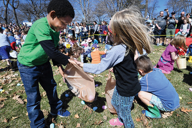 Kids with Easter baskets hunt for Easter eggs.