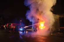 Firefighters spray a controlled burn at the Excelsior Fire District Open House.